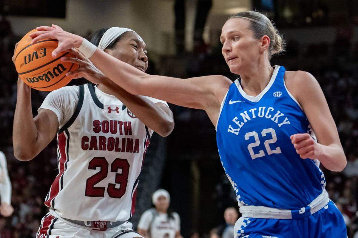 COLUMBIA, SOUTH CAROLINA - JANUARY 15: Maddie Scherr #22 of the Kentucky Wildcats knocks the ball away from Bree Hall #23 of the South Carolina Gamecocks in the third quarter during their game at Colonial Life Arena on January 15, 2024 in Columbia, South Carolina. (Photo by Jacob Kupferman/Getty Images)