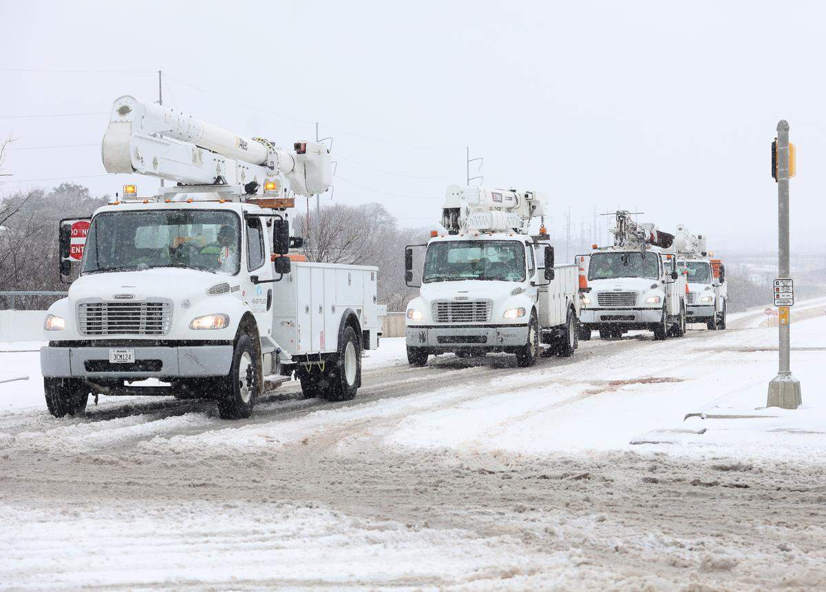 Cherry picker trucks with Higher Power Electric drive along the entrance to Interstate 30 on Thursday, February 3, 2022.