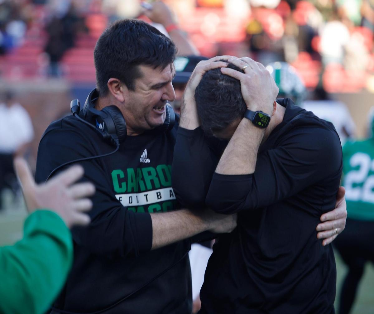Southlake Carroll head coach Riley Dodge reacts with coach Sean Razloznik after winning the UIL 6A D2 Semifinals football game against Longview at Gerald J. Ford Stadium in University Park, Texas, Saturday, Dec. 14, 2024.