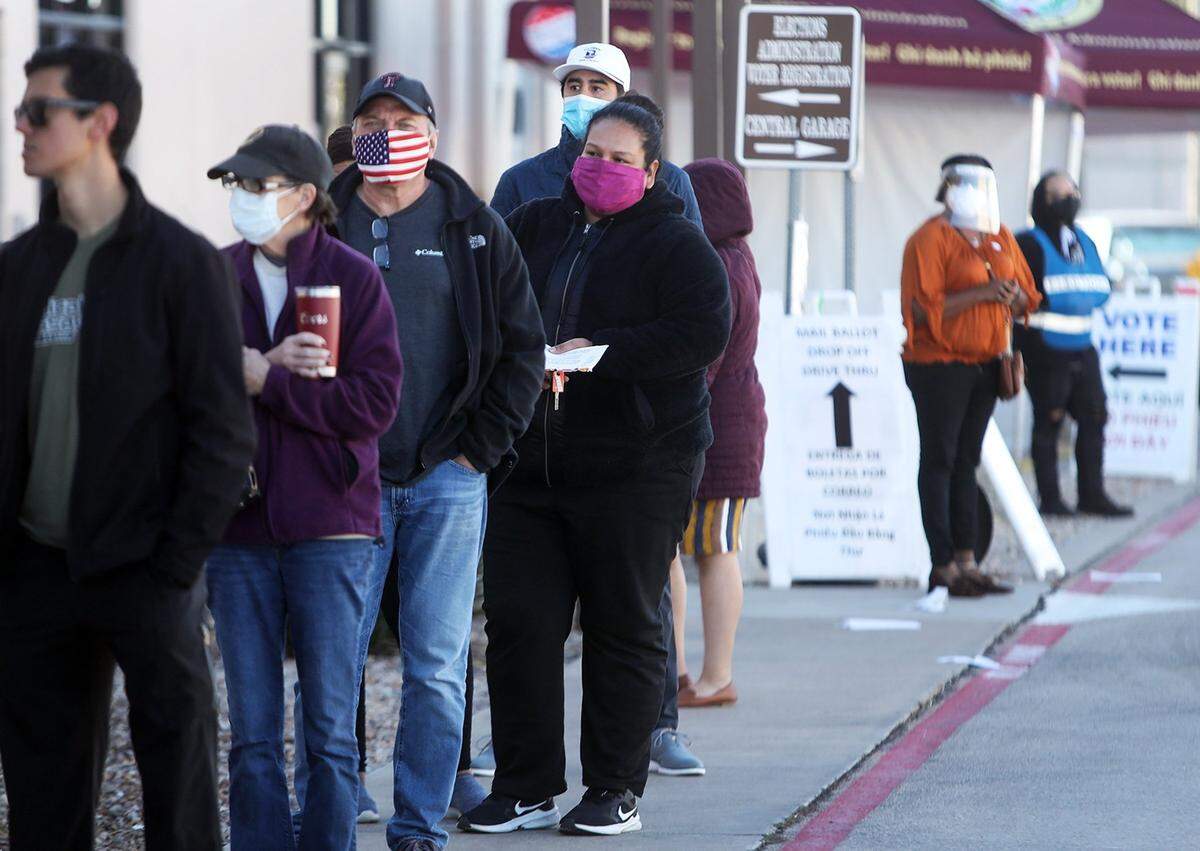 Voters wait in line outside of the Tarrant County Elections Center on Friday, October 30, 2020, to cast their ballots early in primary election.