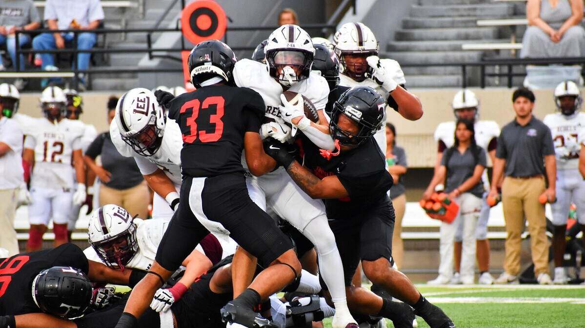 Midland Legacy running back Hayes Hamm is tackled by Euless Trinity defender Vanisi Kongaika (33) in the first quarter of a UIL football Class 6A game at Pennington Field on Friday, Sept. 5, 2025.
