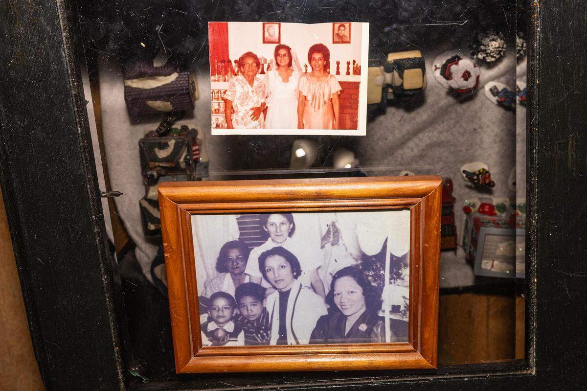 Photos show generations of Diana Garcia Rios’ family. The top photo is from Rios’ wedding day with her grandmother, Tomasa Alejandro, left, and her mother Lucia Alejandro Garcia, right. The bottom photo is from a Christmas family celebration in the 1950s with Rios’ grandmother Tomasa, biological mother Andrea, cousin Frank Alejandro Jr., brother Manuel Alejandro Garcia, mother Lucia, and aunt Amparo Rivera.