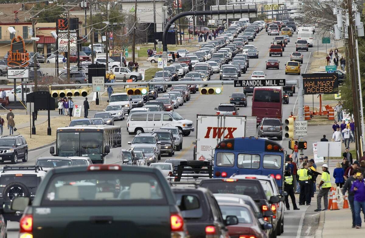 Cars make their way down Collins Street before a Cotton Bowl Classic game at AT&T Stadium Jan. 7, 2011.