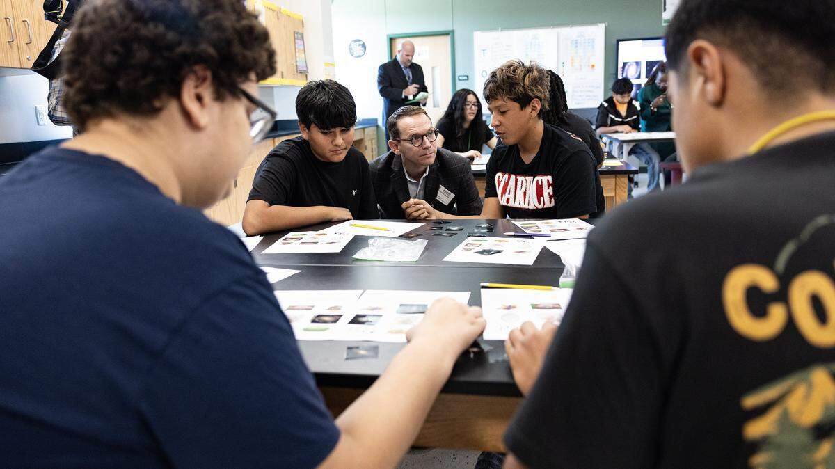 Mike Morath, the Texas Commissioner of Education, interacts with students on their classwork in a science class at Lucyle Collins Middle School in Lake Worth on Tuesday, Oct. 21, 2025. 