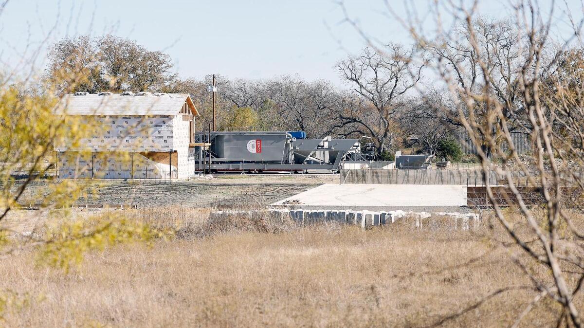 A batch concrete plant is waiting for permits to resume construction in Rendon. David Smith and his neighbors oppose the plant, which is about 200 yards from their backyards. 