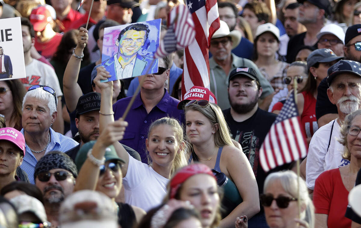 Jazmine Colman holds up a painting she made at the steps of the Tarrant County Courthouse during the rally to honor Charlie Kirk, Saturday, Sept. 20, 2025.