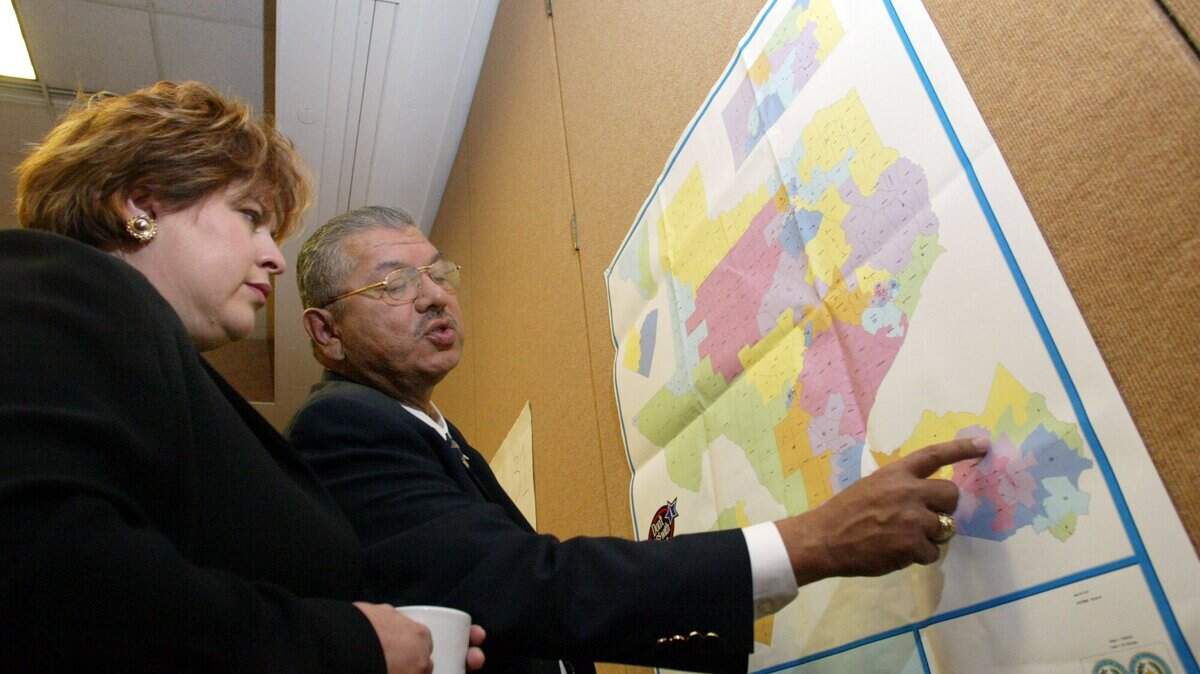 Texas Senators Leticia Van de Putte and Mario Gallegos, Jr. look over a Texas map at the Marriott Hotel in Albuquerque New Mexico, Thursday, July 31, 2003. Democratic state lawmakers fled Texas for the second time in three months to stop a Republican drive to redraw the state’s congressional districts.