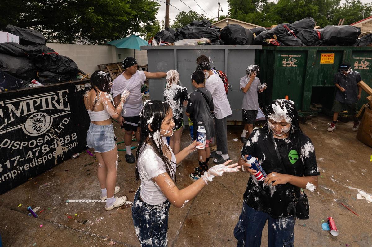 Festival attendees wash off the shaving cream on their bodies on the third day of the Lao New Year festival at Wat Lao Thepnimith Temple in Saginaw on Sunday, April 27, 2025.