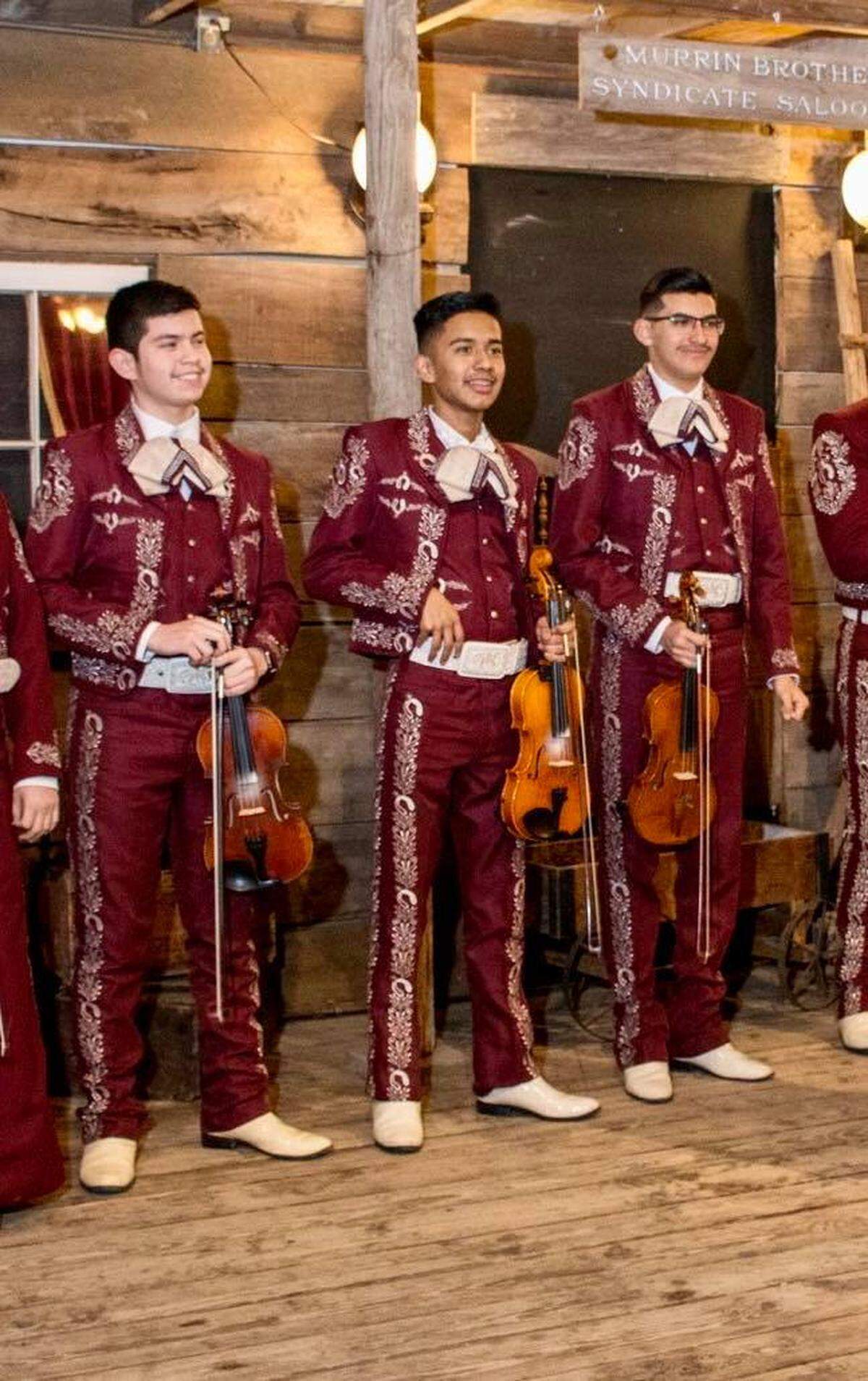 Benjamin Isaac Castaneda Floran (center) smiles with the North Side High School mariachi band. The aspiring mariachi teacher was killed Thanksgiving morning in a crash involving a wrong-way driver in North Richland Hills.