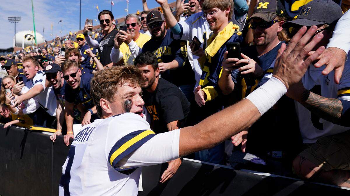 Michigan quarterback J.J. McCarthy (9) celebrates with fans after winning a game earlier this season in Ann Arbor.