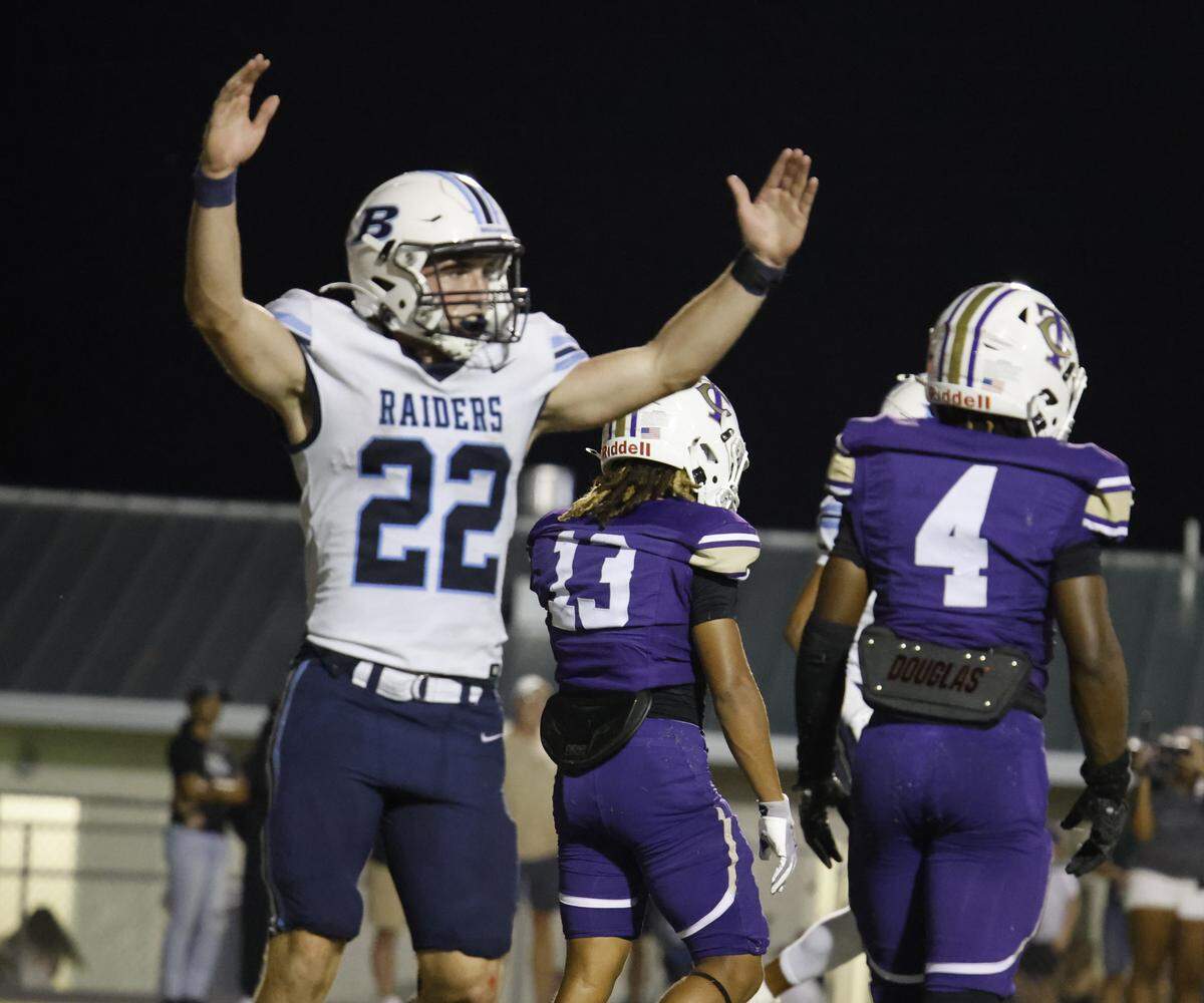 L.D. Bell running back Brendon Gleim (22) signals a successful two-point conversion during the second half of a UIL football game between L.D. Bell and Timber Creek at Keller ISD Athletic Complex in Keller on Thursday, Sept. 11, 2025.