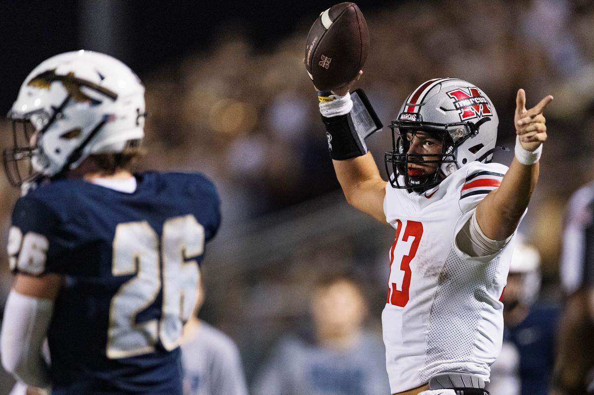 Flower Mound Marcus quarterback Colton Nussmeier points to a first down after a rushing attempt in the first quarter of a non-district game between Keller and Flower Mound Marcus at Keller ISD Stadium on August 28, 2025.