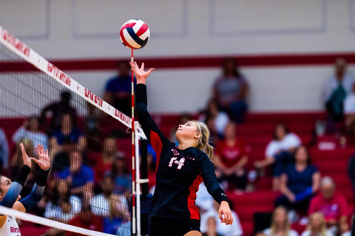 Morgan Howard (14) sets with one hand during a district match between Colleyville Heritage and Grapevine at Grapevine High School on October 4th 2022.