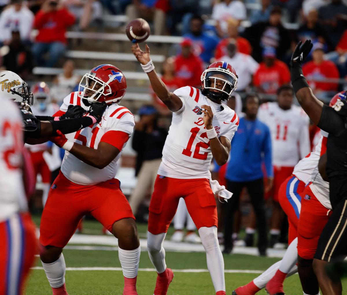 Duncanville quarterback Keelon Russell (12) throws the first touchdown pass of the game in the first half of a UIL high school football game at Vernon Newsom Stadium in Mansfield, Texas, Thursday, Oct. 12, 2023.
