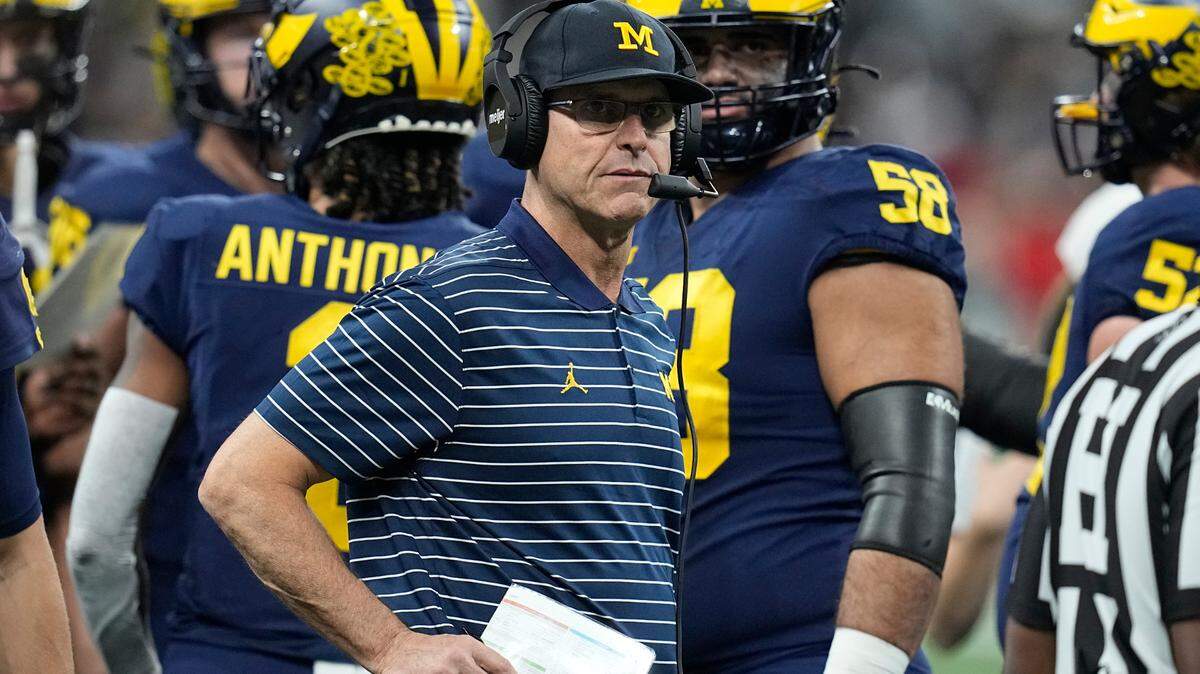 Michigan head coach Jim Harbaugh watches from the sidelines during the first half of the Big Ten championship NCAA college football game.