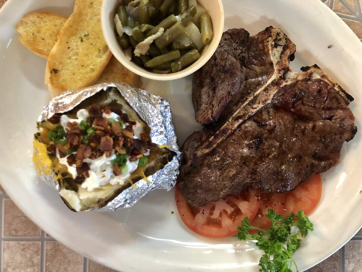 The steak platter at La Rueda, with a baked potato and side dish.