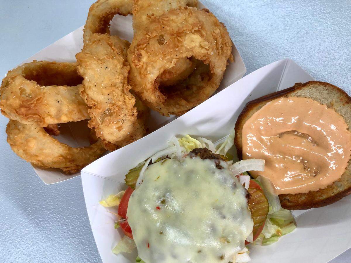 The Ten Pepper Burger with onion rings at The Original Chop House Burgers in Arlington.
