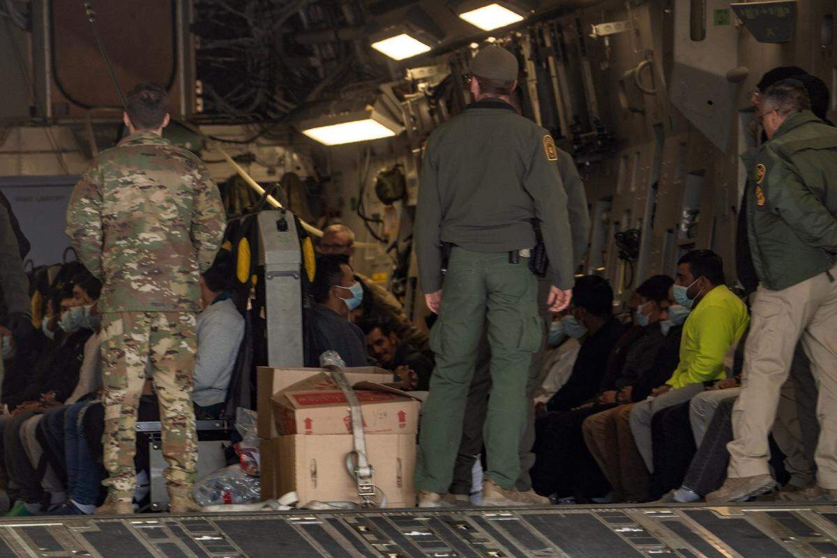 Migrants in the United States illegally are loaded onto a C-17 military plane to be deported on Jan. 30, 2025 at Fort Bliss in El Paso, Texas. The aircraft is designed to transport 134 passengers but only carried 80 migrants.