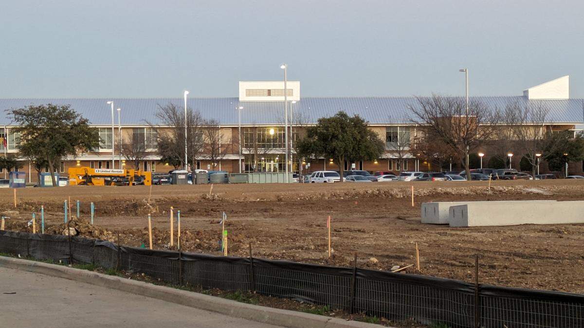 Keller school district officials voted to authorize purchasing land next to Basswood Elementary School as a way to block a proposed motel project.