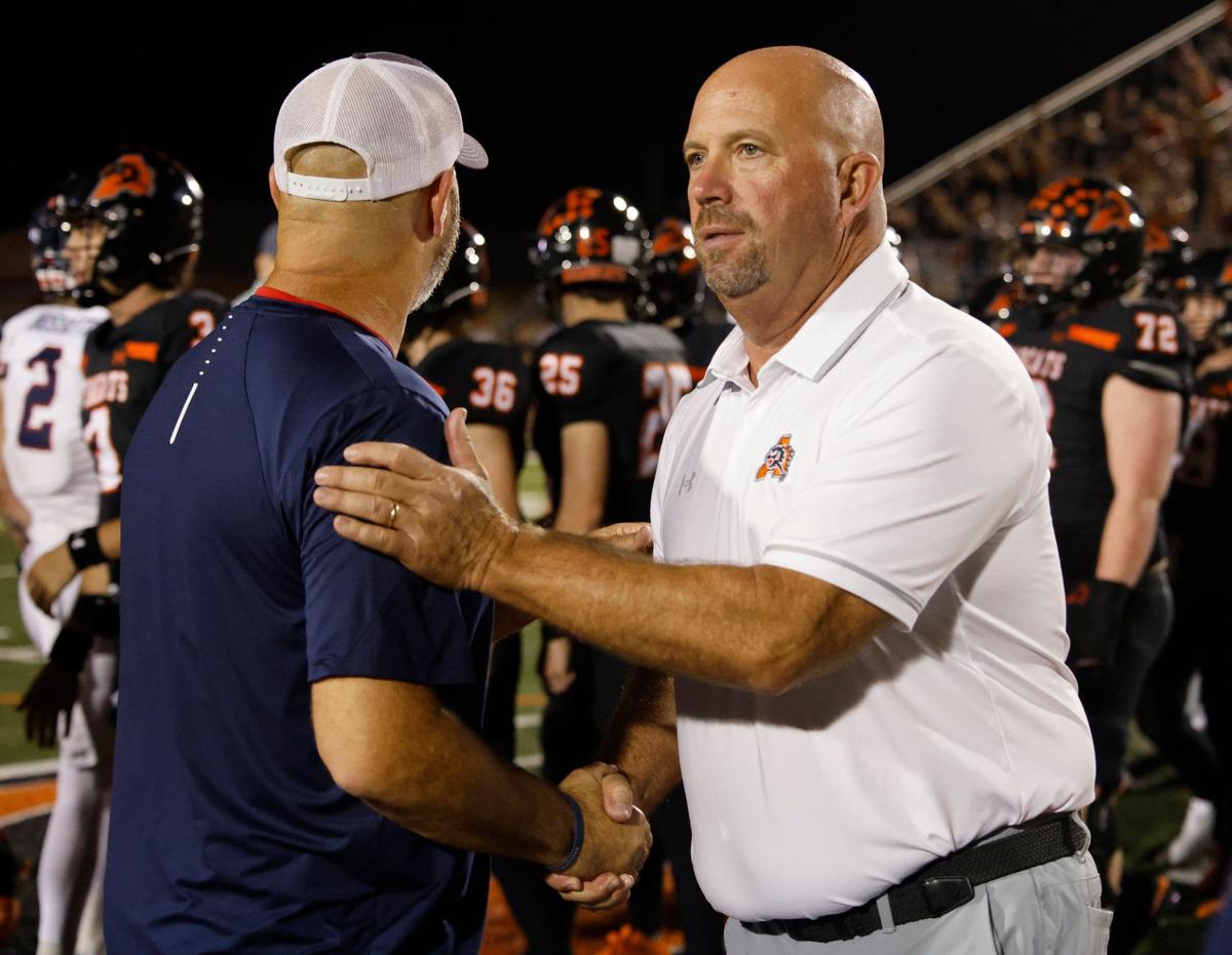 Aledo head coach Robby Jones and Denton Ryan head coach Dave Henigan share pleasantries after their UIL football game at Buchanan Stadium in Aledo Texas, Friday, Oct. 04, 2024.