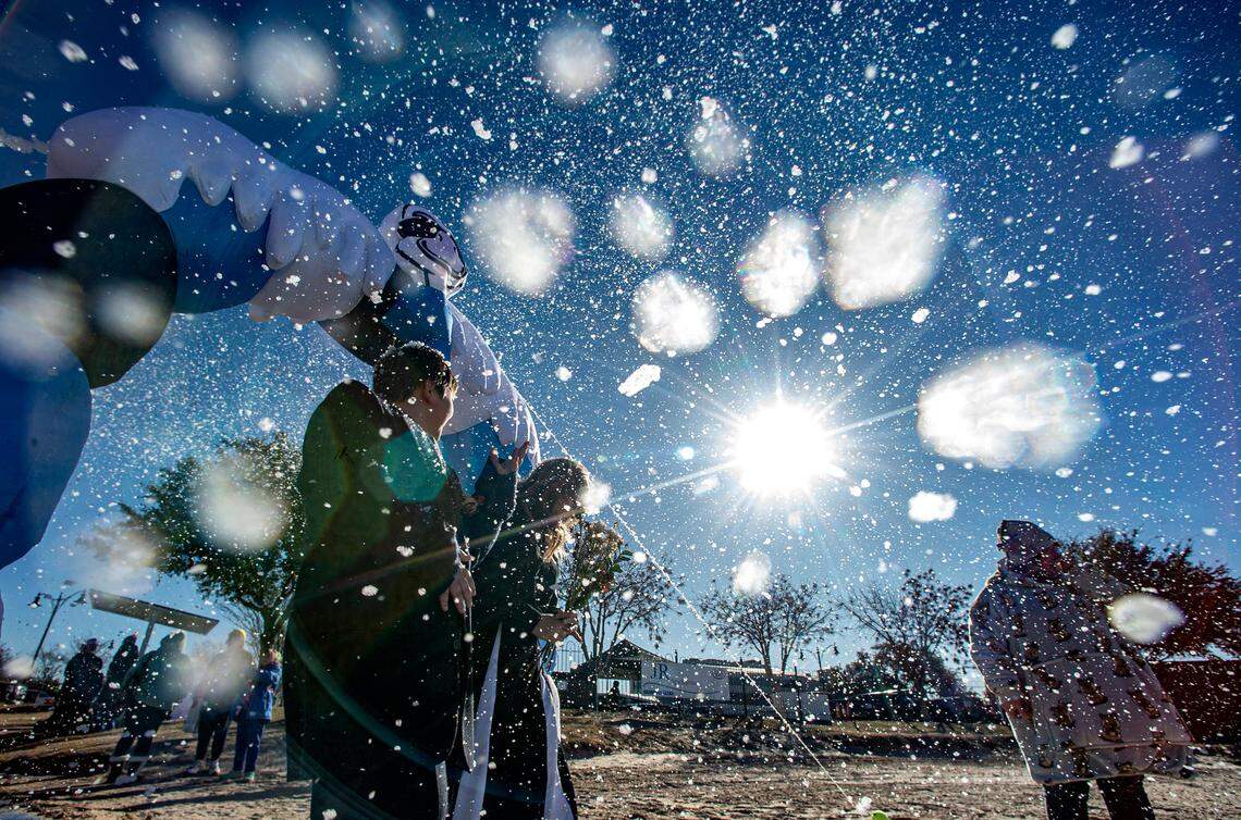 A snow machine feted costumed participants at Granbury’s fourth annual Goosebump Jump as they walked the blue carpet to the beach. Duncan Kelley, 12, left, and Charlotte Sorrells, 13, came as prom dates.