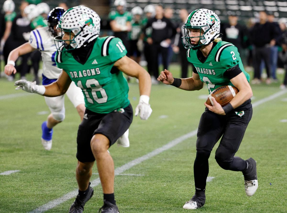 Carroll quarterback Angelo Renda (2) follows his blocker Christian Glenn (18) around the left side during the second half of a UIL Conference 6A Division 2 quarterfinal football playoff game at Choctaw Stadium in Arlington, Texas, Saturday, Dec. 02, 2023. Carroll defeated Byron Nelson 56-7. (Special to the Star-Telegram Bob Booth)