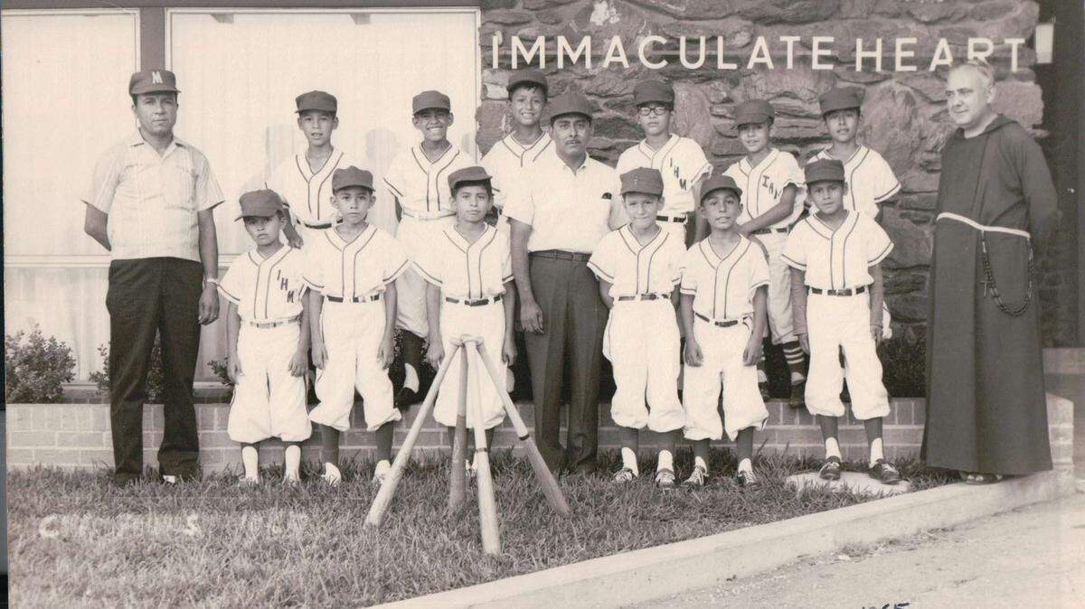 The Immaculate Heart of Mary baseball team won the 1965 Catholic Athletic League baseball championship. Coach Nick Martinez is on the far left, Ciquio Vasquez is in the middle, and Father Jerome Lecumberri is on the far right.