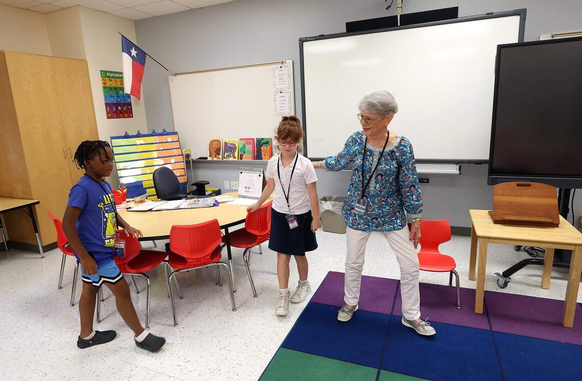 Retired teacher Martha Farr, right, walks second graders Malachi Murkledove, left, and Gabriela Ringnald back to class after a tutoring session in reading at Westpark Elementary School on Thursday, Sept. 19, 2025. 