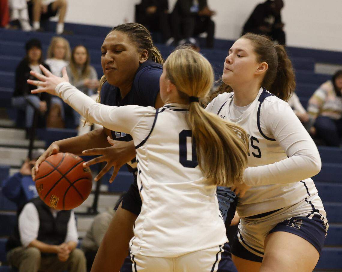 L.D. Bell point Madi Capers (23) is double covered under the net during the first half of a UIL girls basketball game between L.D. Bell and Keller at Keller High School in Keller, Texas, Friday Jan. 16, 2026