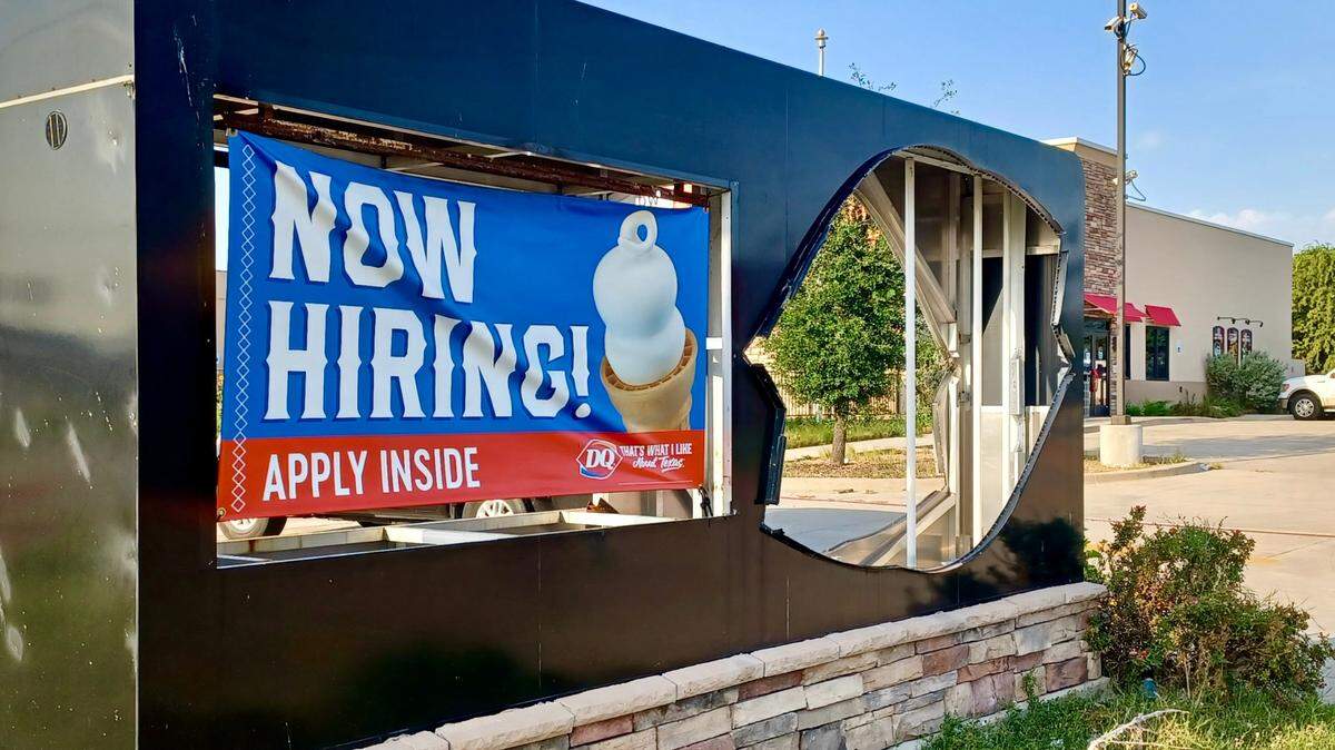 A “now hiring” sign is up at a reopening Dairy Queen location.
