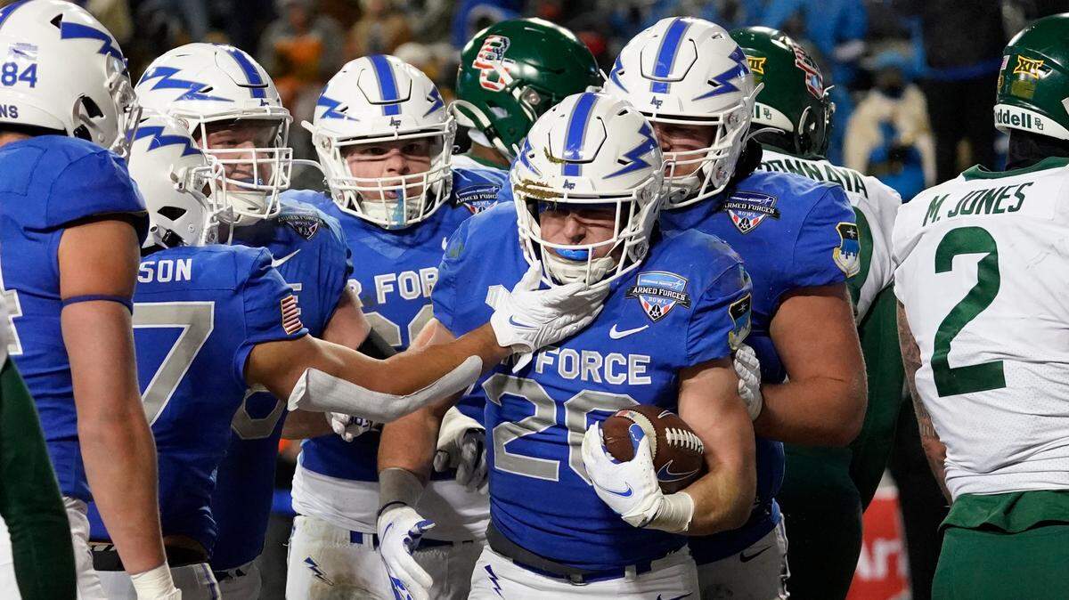 Air Force running back Brad Roberts (20) is congratulated by teammates after scoring a touchdown against Baylor during the first half of the Armed Forces Bowl at Amon G. Carter Stadium on Thursday.