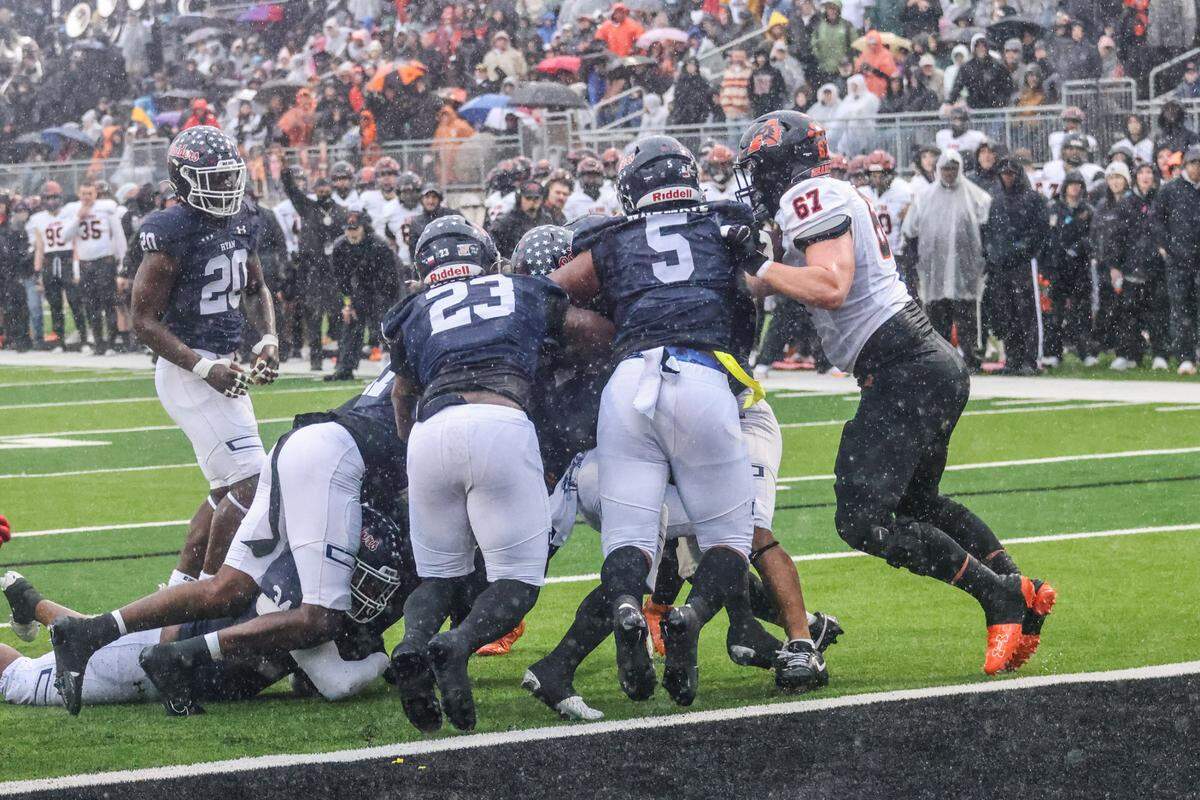 The Denton Ryan defense gang tackles an Aledo runner in a Class 5A Division 1 state quarterfinal on Saturday, Dec. 7, 2024 at Crowley ISD Multi-Purpose Stadium in Fort Worth, Texas.