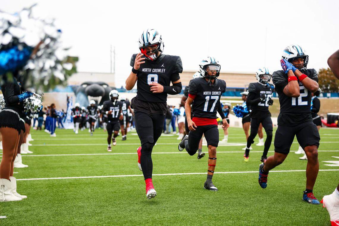 North Crowley players, including quarterback Hayes Cloutier (9), run out before a UIL 6A Division I Regional playoff game at Midlothian ISD Stadium in Midlothian on Saturday, Nov. 29, 2025.
