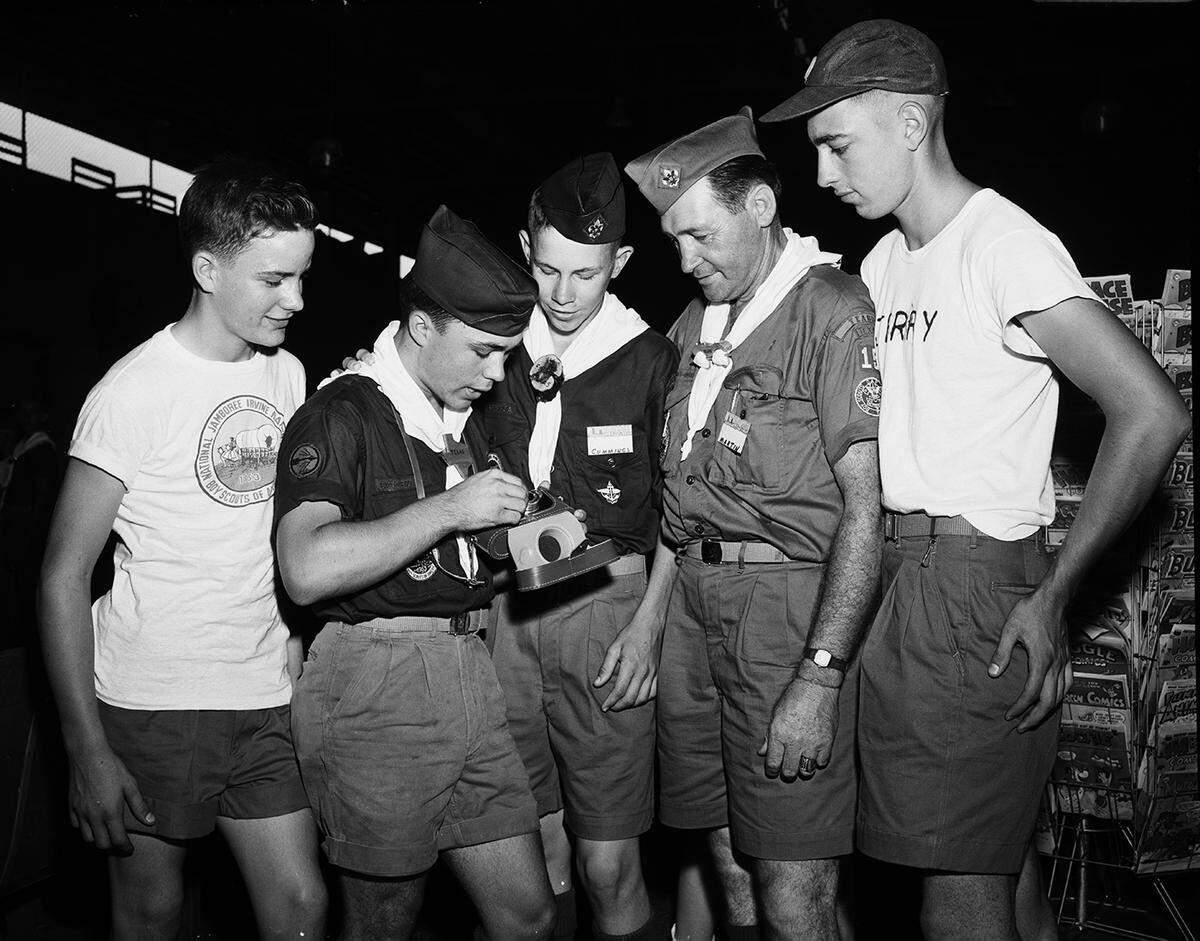 July 8, 1953: Five Boy Scouts study the camera they will use to record events during the national Boy Scout Jamboree in California. The boys stopped in Fort Worth en route to the jamboree. Left to right, Ray Green, 13, of Cameron; Tommy Massey, 16, of Teague; Bob Cummings, 16, of Gatesville; Jim Martin of Teague, scoutmaster, and Jerry Gritter, 16, of Waco.
