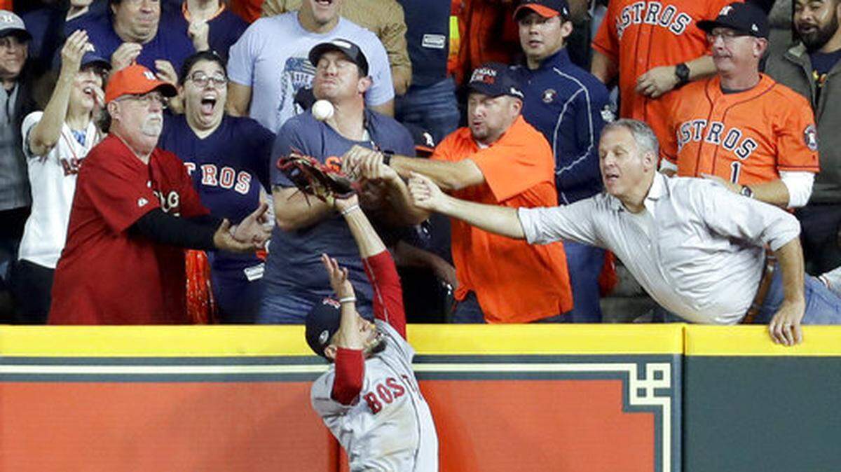 Fans interfere with Boston Red Sox right fielder Mookie Betts trying to catch a ball hit by Houston Astros’ Jose Altuve during the first inning in Game 4 of a baseball American League Championship Series on Wednesday, Oct. 17, 2018, in Houston. Altuve was called out. (AP Photo/Frank Franklin II)
