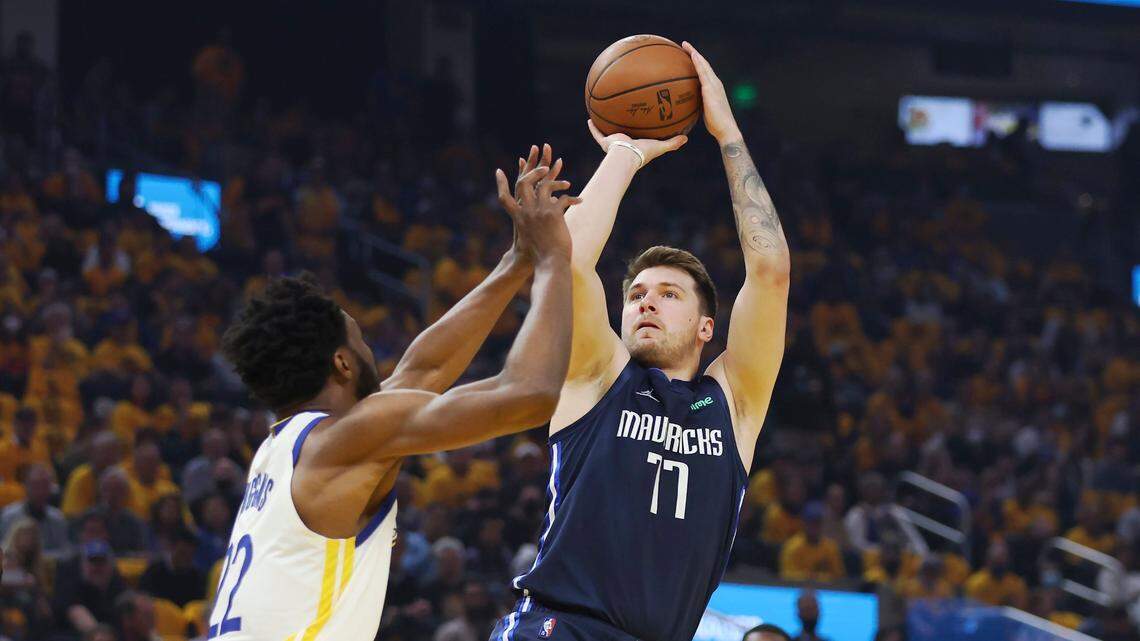 Dallas Mavericks guard Luka Doncic (77) shoots against Golden State Warriors forward Andrew Wiggins during the first half of Game 2 of the NBA basketball playoffs Western Conference finals in San Francisco, Friday, May 20, 2022. (AP Photo/Jed Jacobsohn)