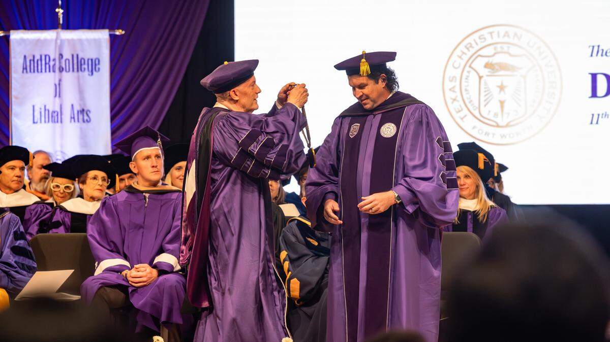 TCU Chancellor Emeritus Victor Boschini presents Daniel Pullin, the university’s new chancellor, with a symbolic medallion at Pullin’s inauguration ceremony at the Van Cliburn Concert Hall inside TCU’s Megan and Victor Boschini Music Center on Nov. 6, 2025.