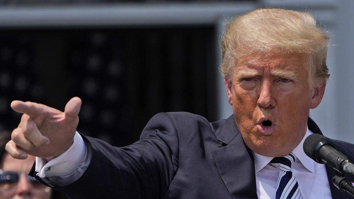 Donald Trump imitates the shooting of a gun with his finger while talking about gun violence in Chicago as he speaks at Trump National Golf Club in Bedminster, N.J., Wednesday, July 7, 2021. (AP Photo/Seth Wenig)