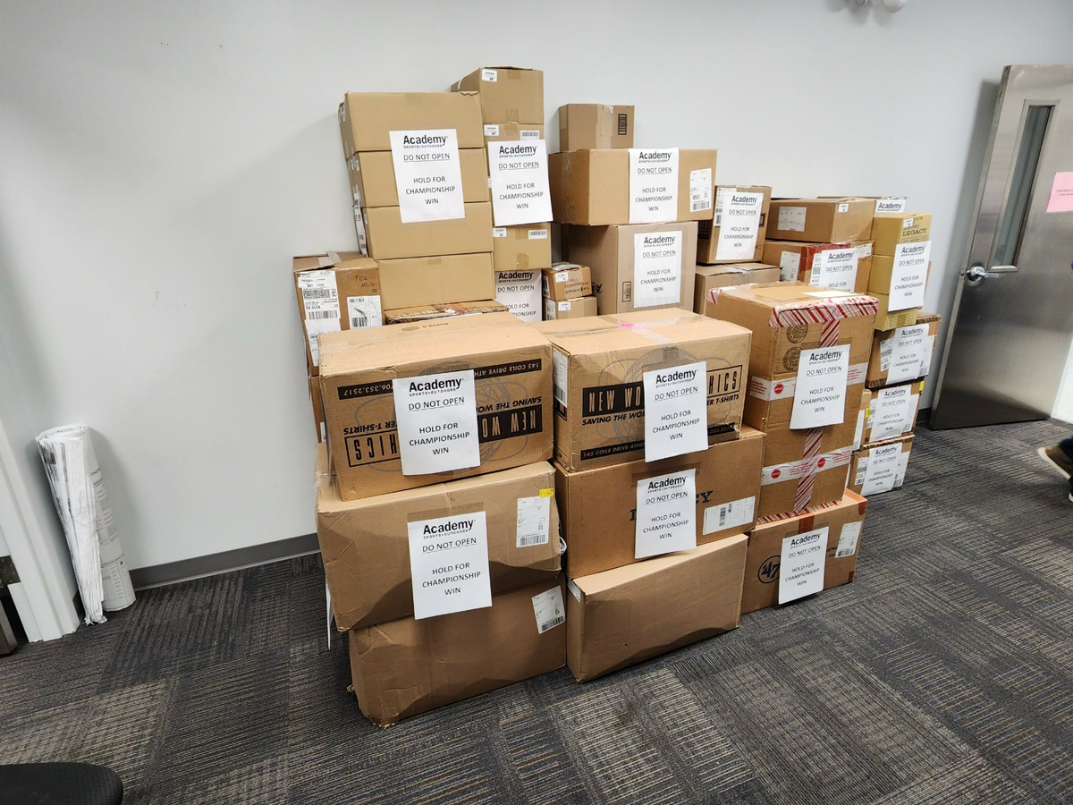Unopened boxes of TCU National Champions gear sits at a Fort Worth Academy Sports + Outdoors.