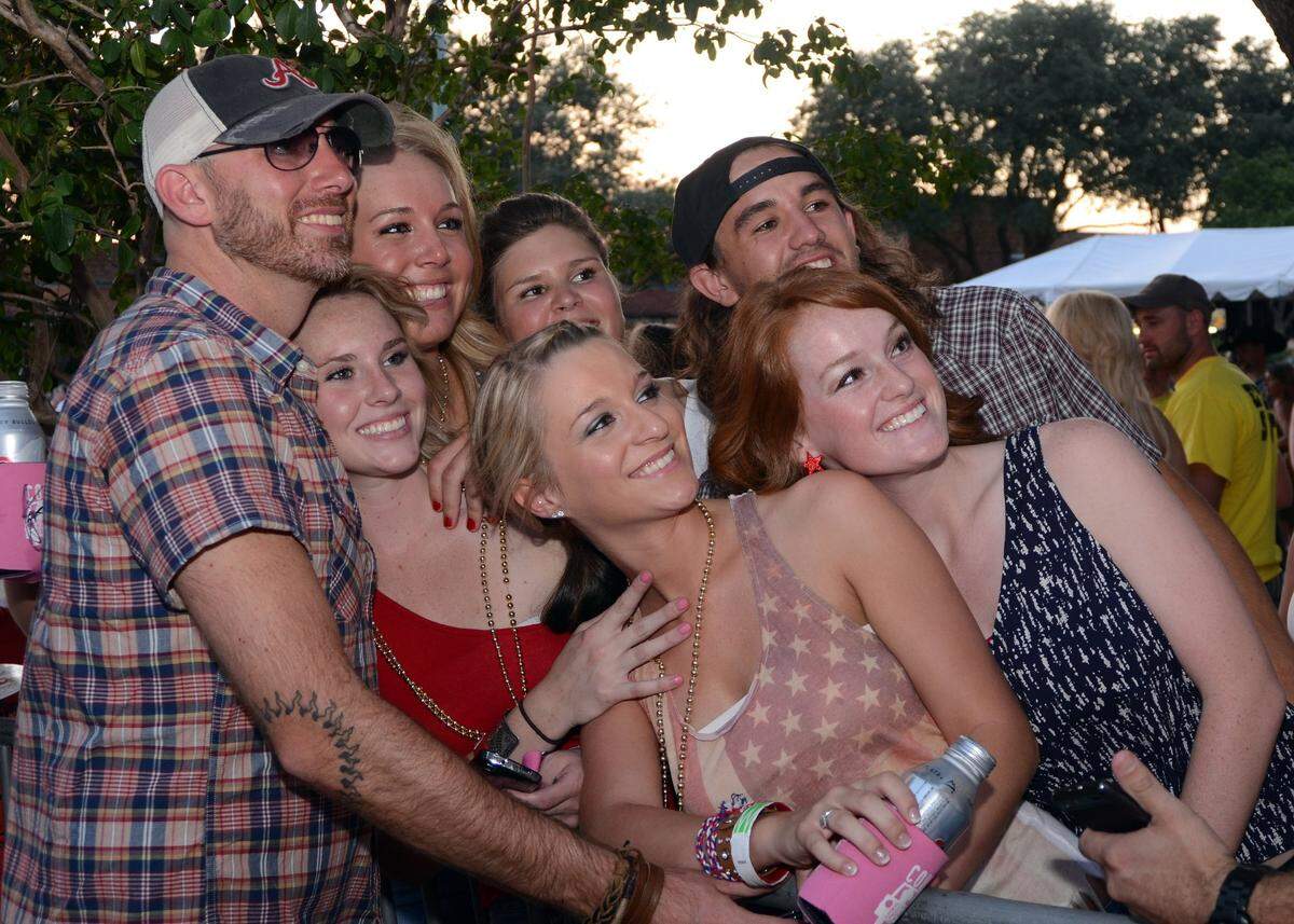 July 4, 2012: Singer songwriter Cory Smith has his picture made with fans after his performance at Willie Nelson’s Fourth of July Picnic at the Billy Bob’s Texas