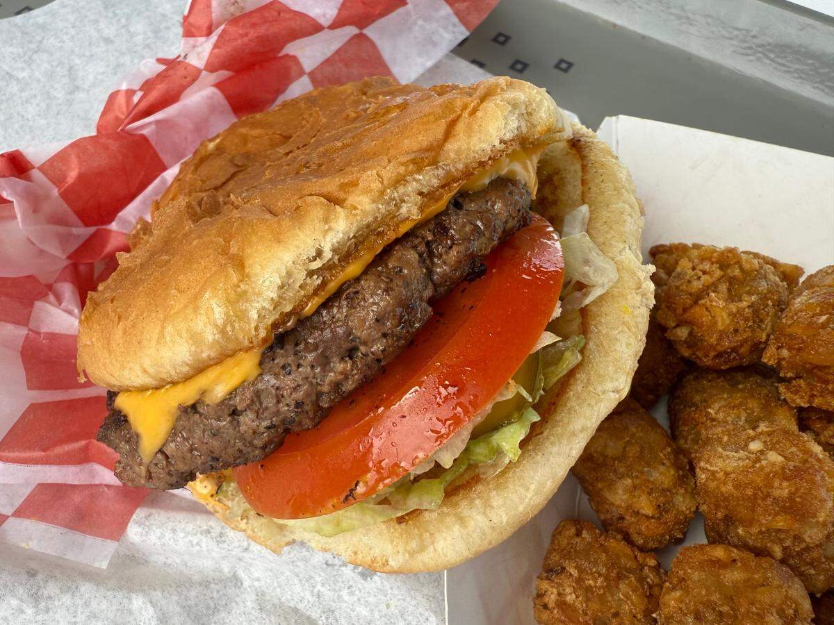 A cheesburger and tater tots seen June 15, 2025, at the Malt Shop, an old-time drive-in nearing 70 years on U.S. 180 at the east edge of Weatherford, Texas.