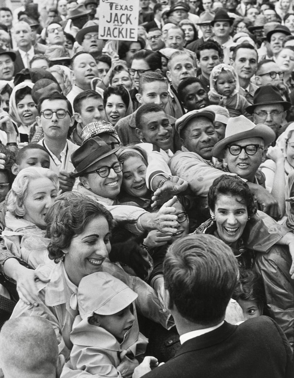 Gene Gordon’s photo of crowds greeting President John F. Kennedy was used for the cover of the art exhibit “Hotel Texas” of paintings gathered for the President’s hotel suite.