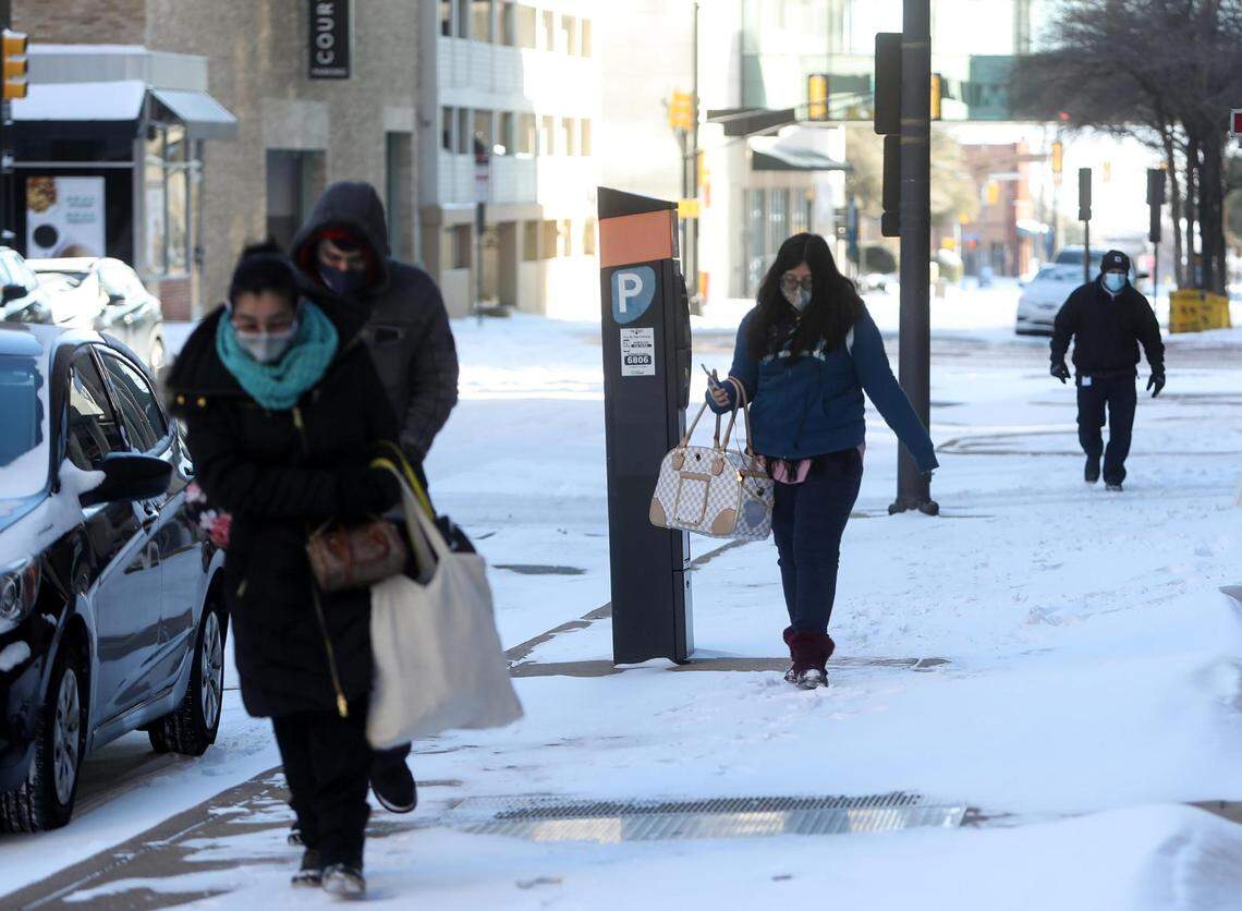 People walk through downtown Fort Worth on Feb. 15, 2021.