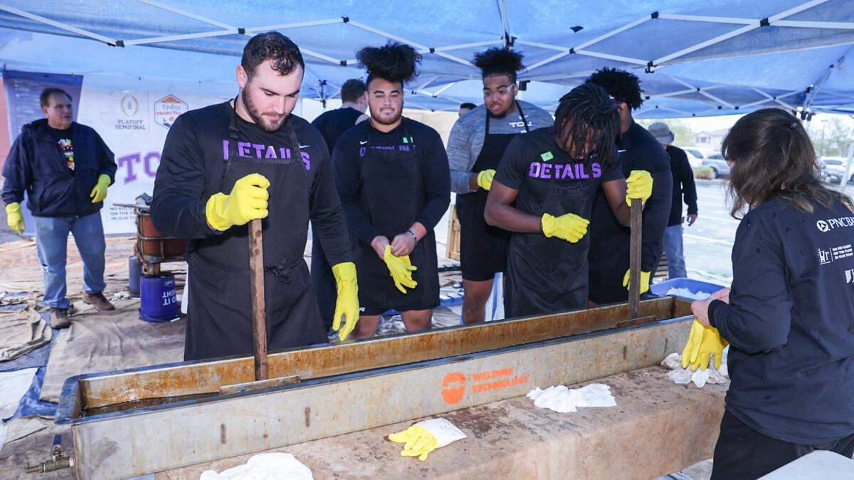 TCU players put together beds for children in need ahead of the Fiesta Bowl in Scottsdale, Arizona on Dec. 28, 2022.