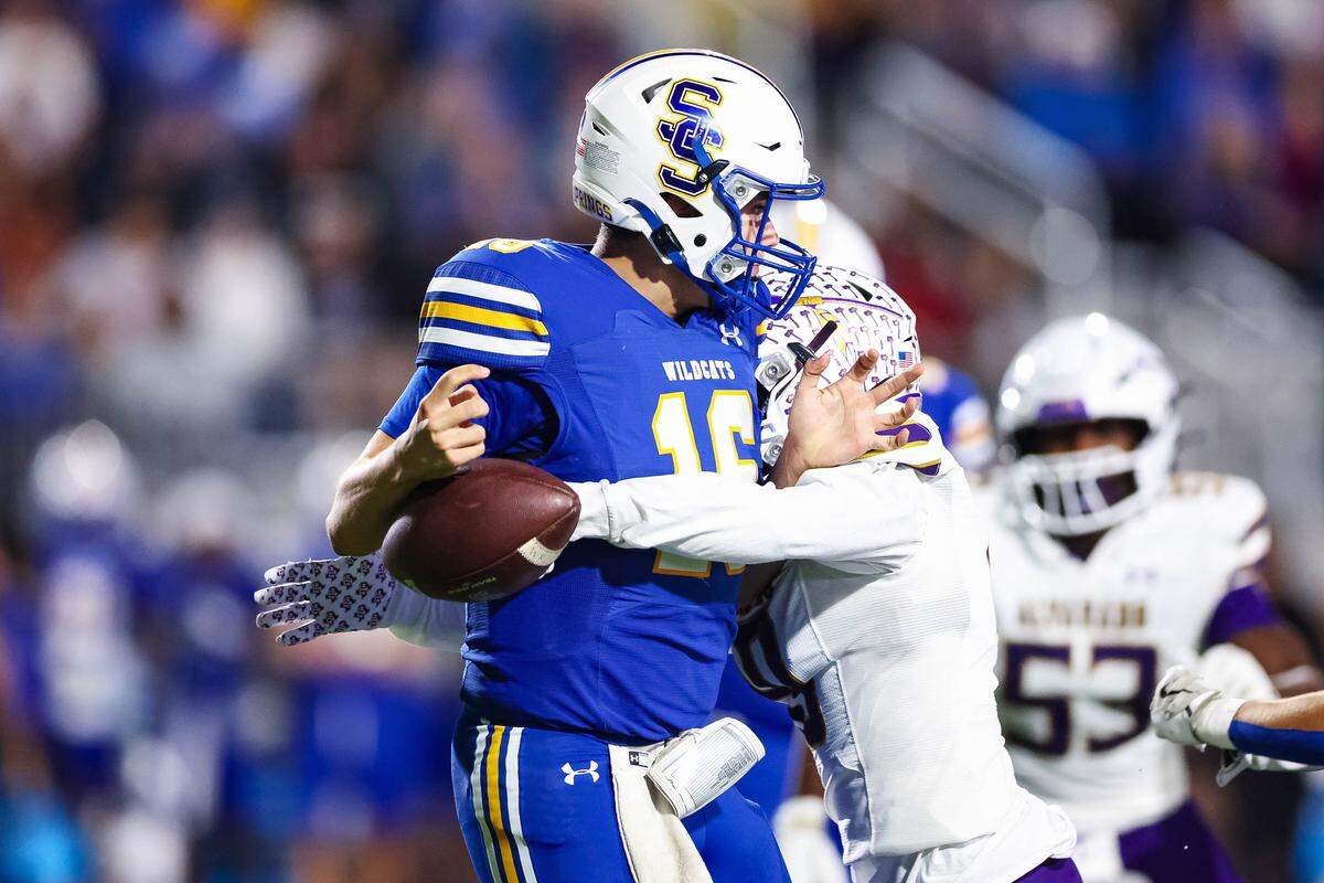 An Alvarado defensive lineman forces a fumble by Sulphur Springs quarterback Mason Cooper (16) in a Class 4A Division I area playoff game Friday, Nov. 21, 2025, at Children’s Health Stadium in Prosper, Texas.