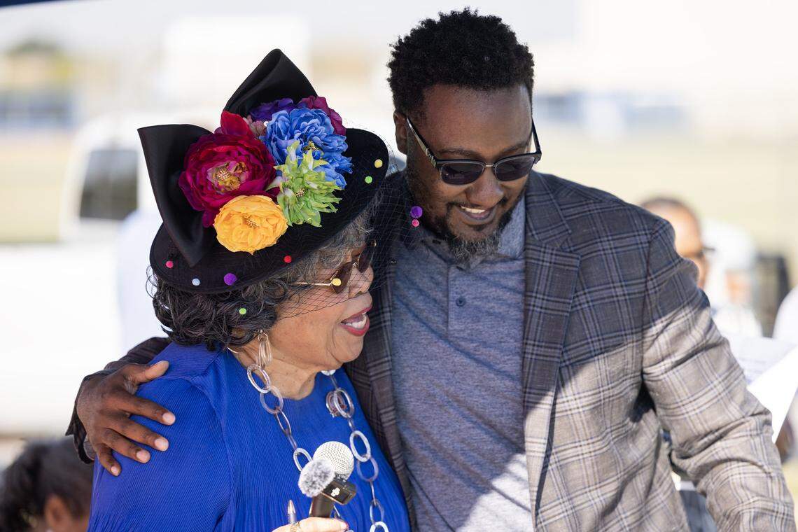 Former Dunbar principal Shirley Knox Benton, left, embraces the current Dunbar principal Justin Edwards during her street topper dedication ceremony outside Dunbar High School in Fort Worth on Thursday, Oct. 2, 2025. 