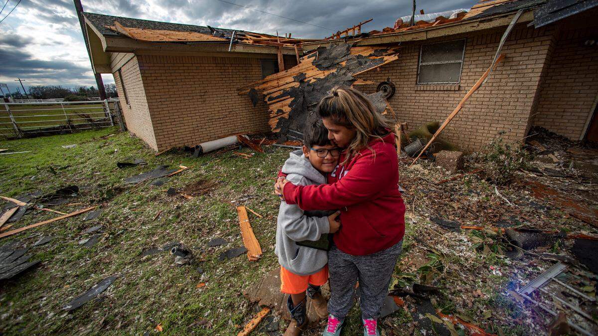 Isabella Gonzalez and her son, Damien, in front of what is left of their home. A tornado touched down just south of Decatur, Texas, along FM 730 early morning Tuesday, Dec. 13, 2022, tearing the roof off of a home and ripping trees in half. Debris was strewn across the highway.