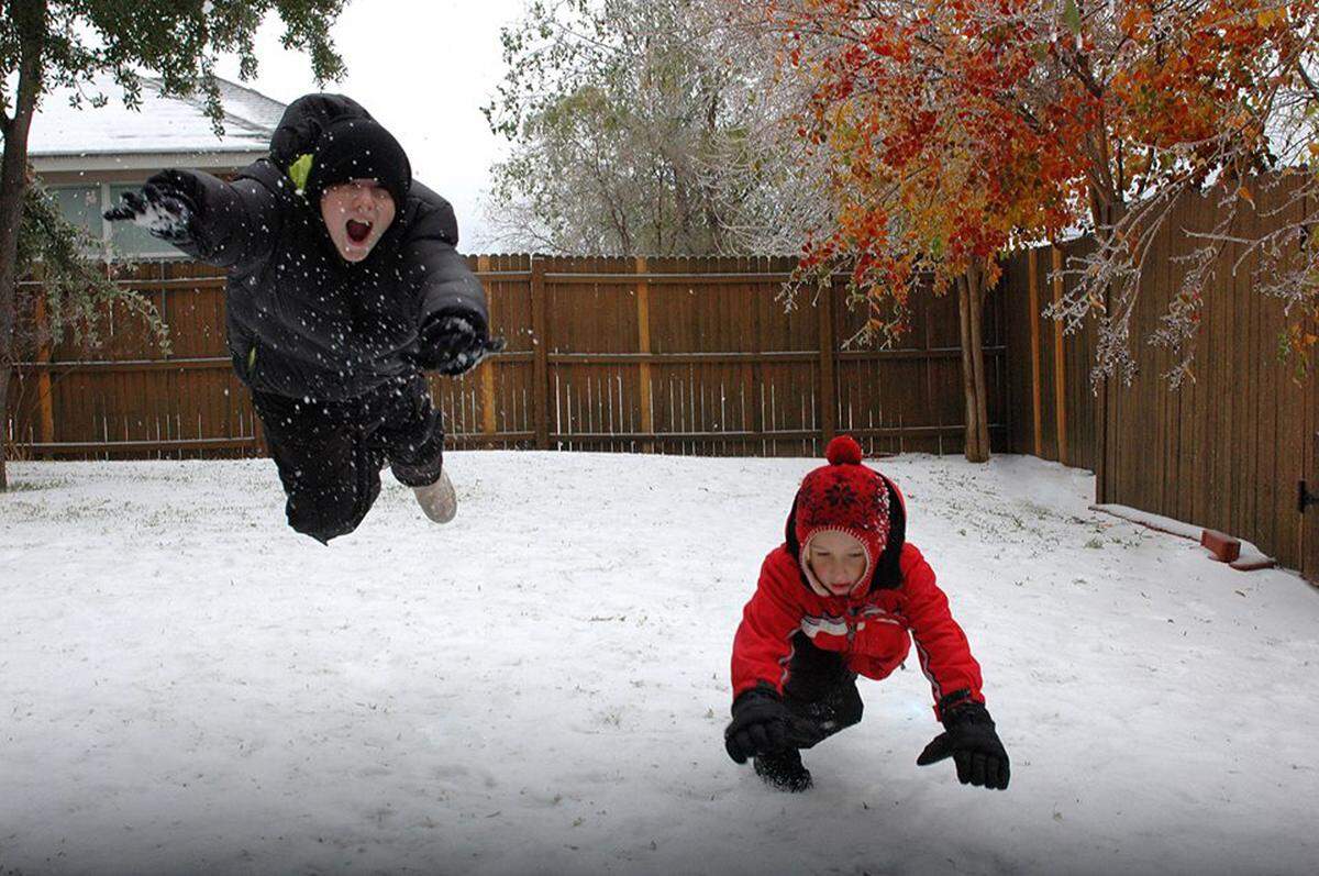 Dec. 11, 2013: Parker, 12, and Caden Yowell, 7, enjoy the day off school and the snow and ice in Mansfield.