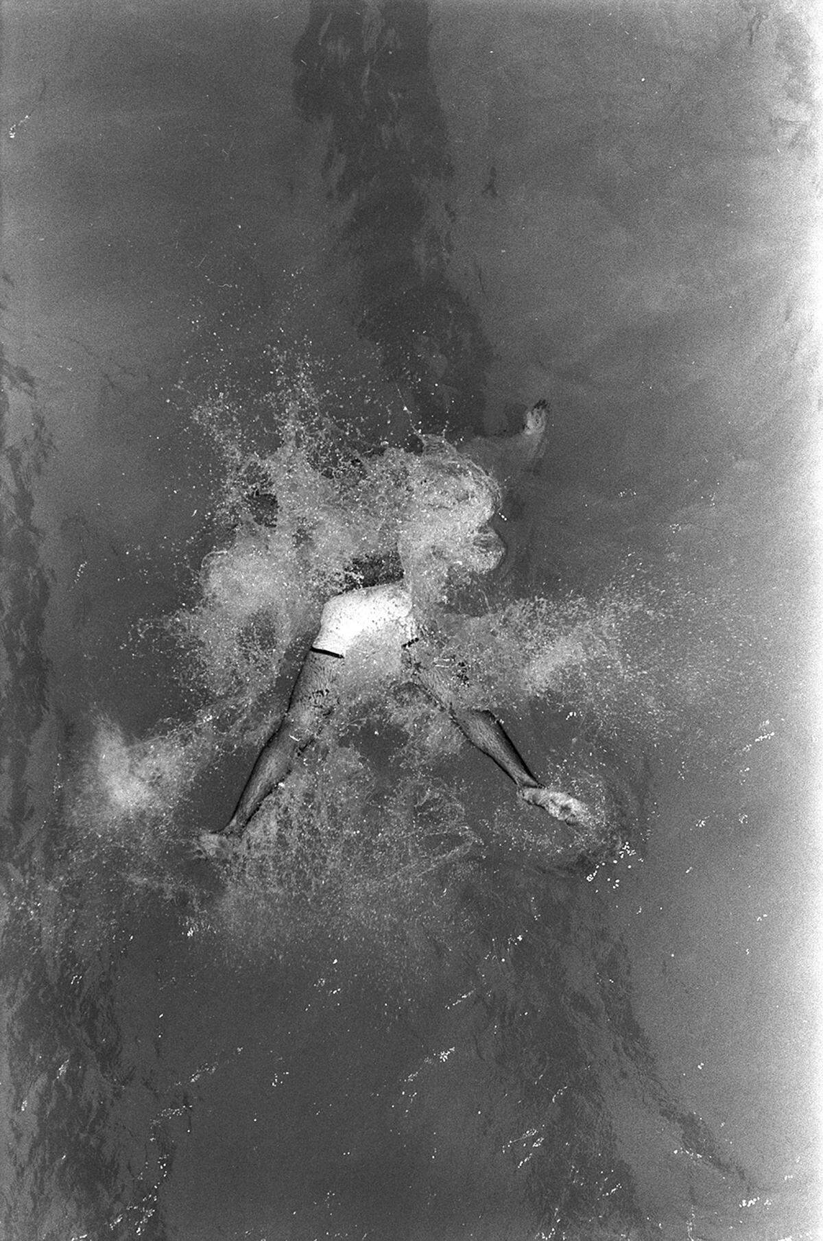 June 27, 1980: A University of Texas at Arlington student participates in the non-invitational belly flop competition on campus during a heat wave.
