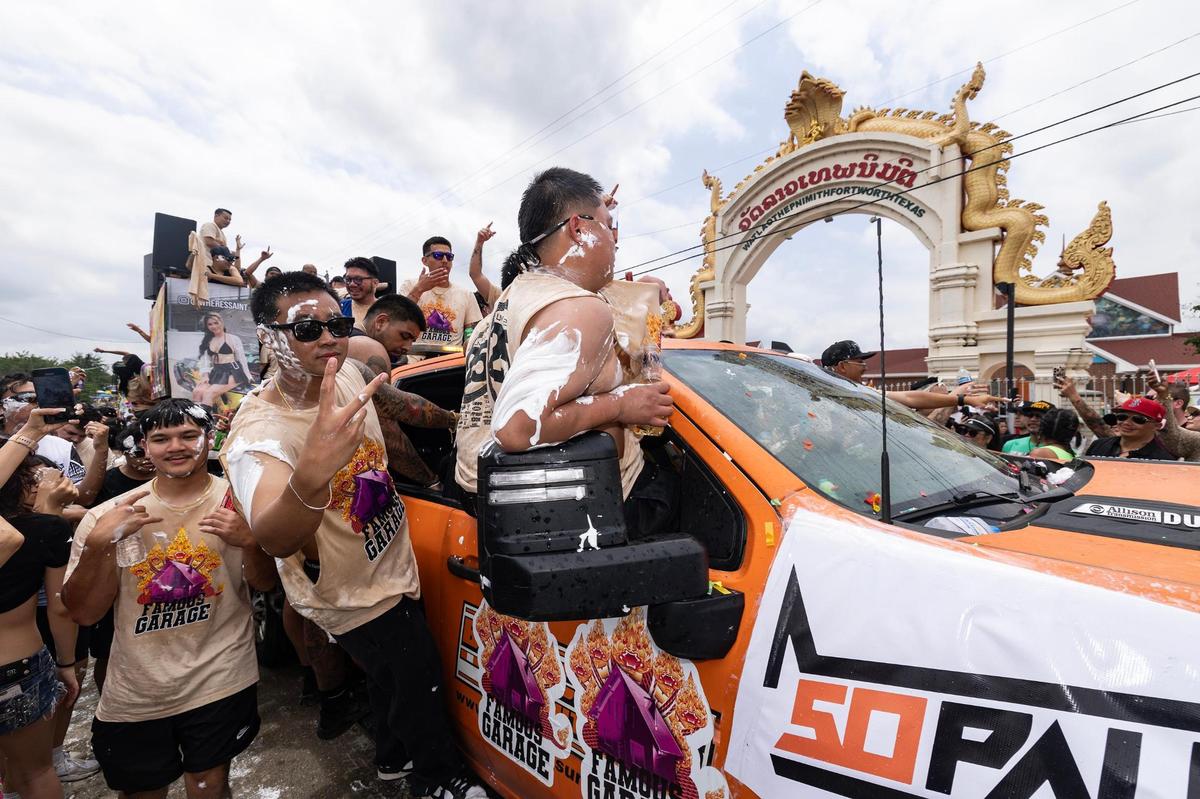 Festival attendees pack the streets and drive by the temple during the Lao New Year parade on the third day of the Lao New Year festival at Wat Lao Thepnimith Temple in Saginaw on Sunday, April 27, 2025.